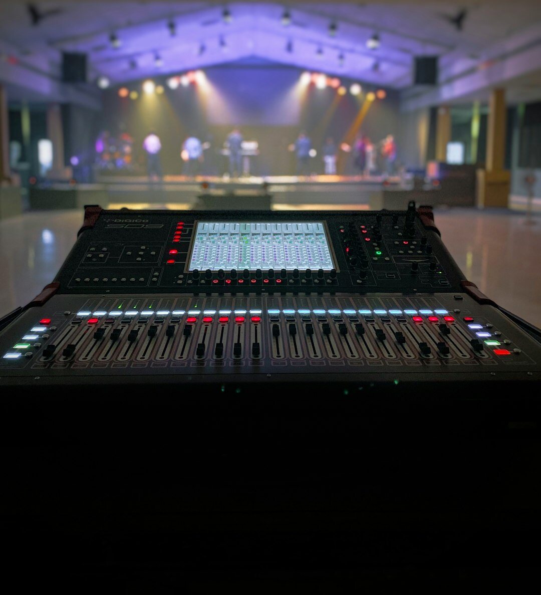 Australian male instructor teaching live studio production at a console